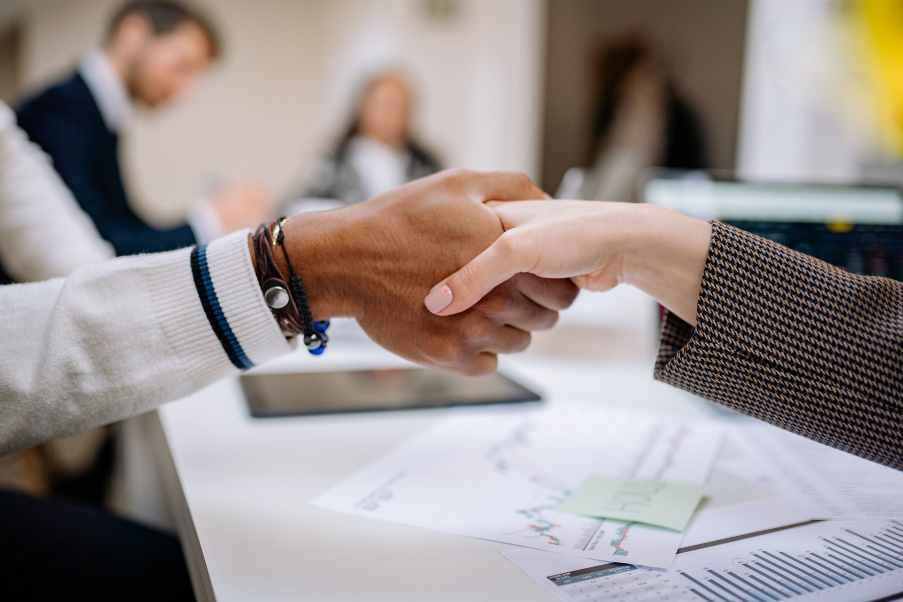 A compliance handover between two colleagues at a desk